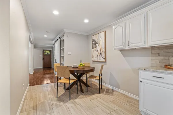 an empty room with floor to ceiling window and wooden floor