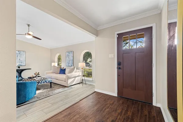 a living room with furniture and wooden floor