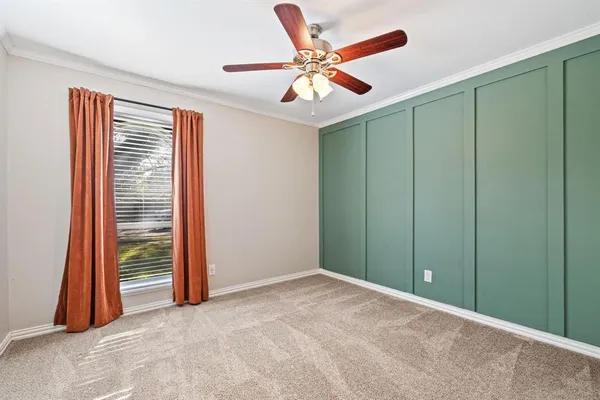 an empty room with closet and a chandelier fan