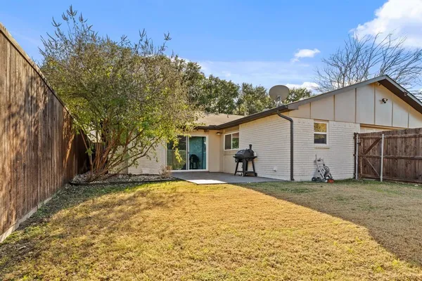 a view of backyard with large tree