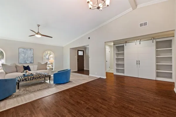 a view of a livingroom with furniture wooden floor and window