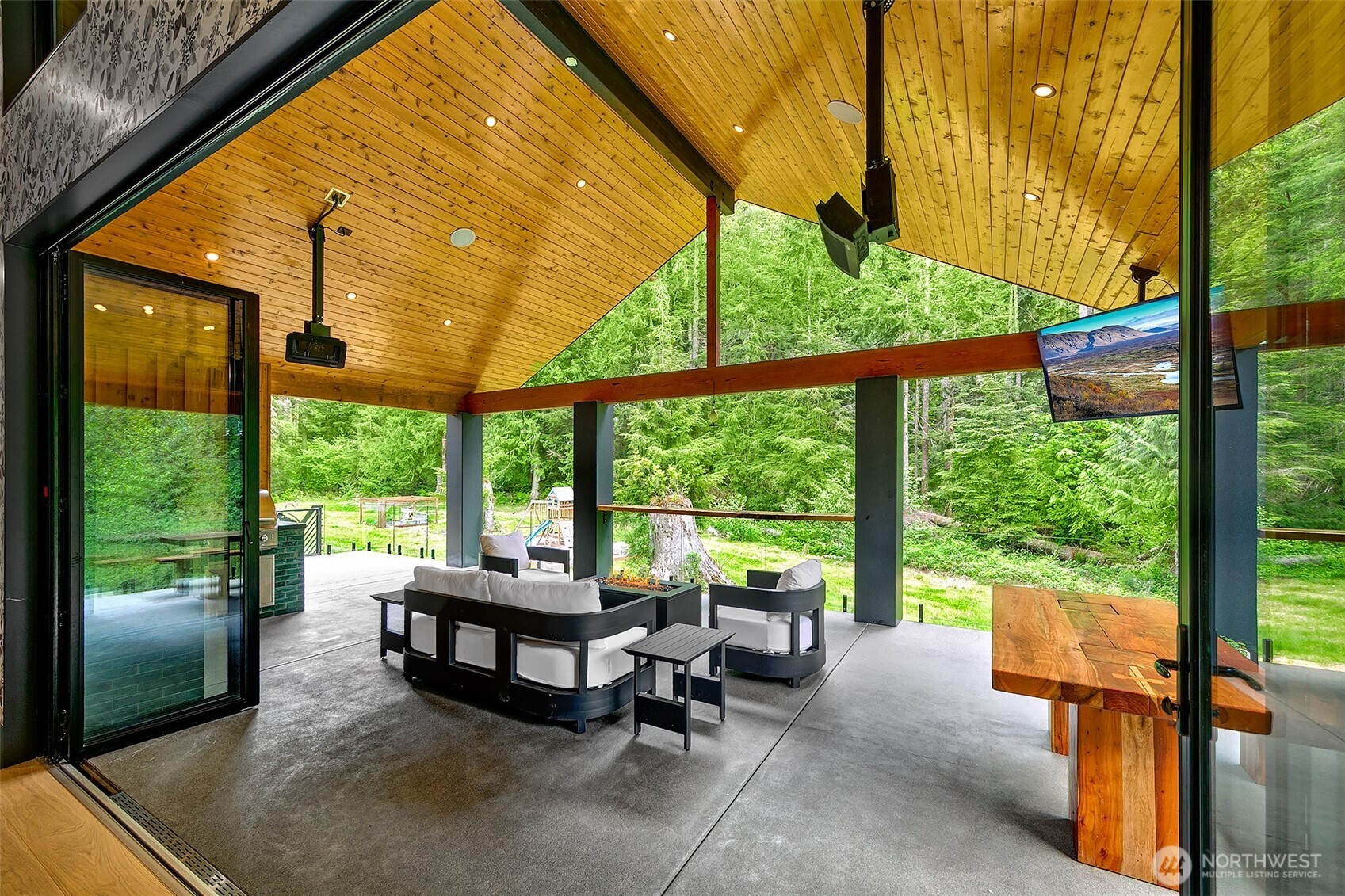 7538 Moon Valley Road Southeast North Bend, WA 98045 - Photo 7 of 40 a living room with furniture and floor to ceiling windows