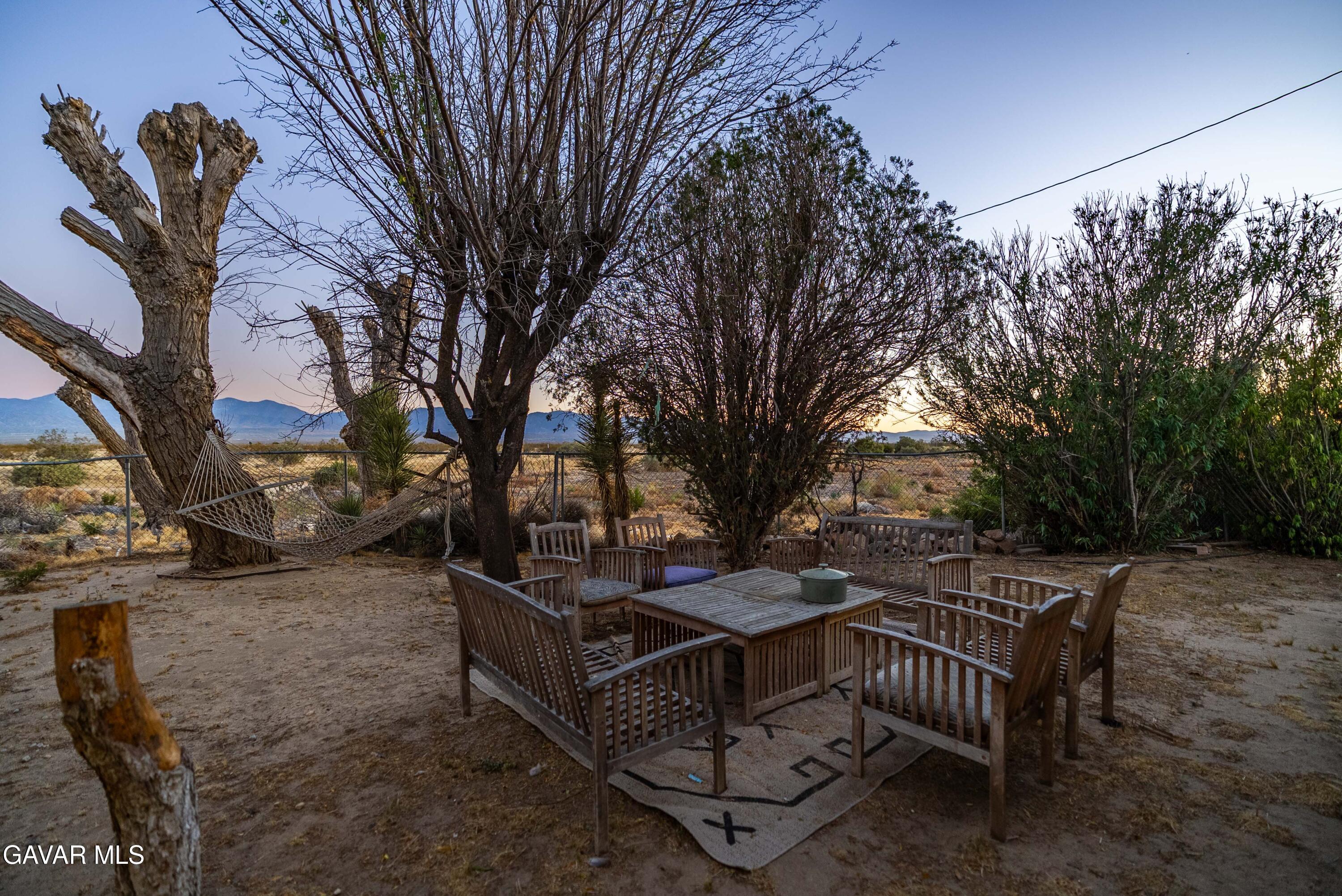 20539 East Ave R Palmdale, CA 93591 - Photo 13 of 55 a view of backyard with trees and outdoor seating