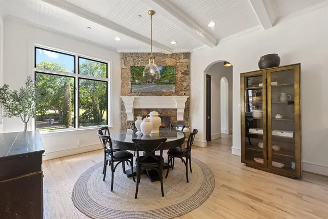 a dining room with furniture a chandelier and wooden floor