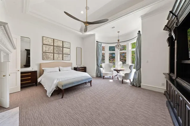 a spacious bedroom with a bed couch and a window