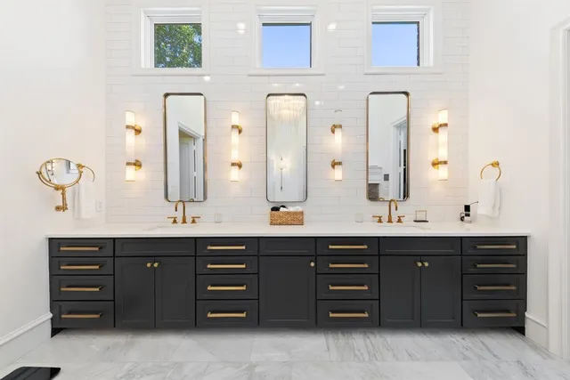 a bathroom with a double vanity sink and a large mirror