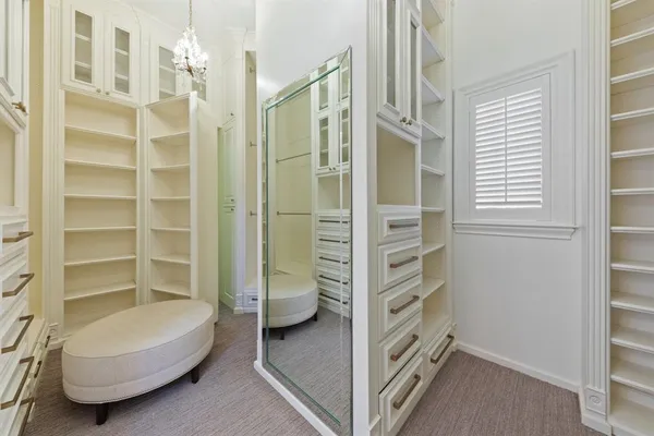 a view of walk in closet with empty racks