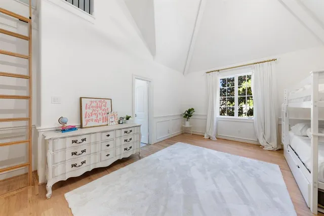 a view of a bedroom with furniture and windows