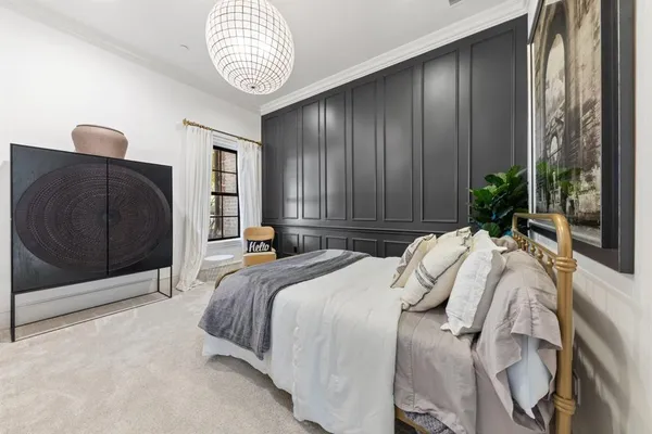 a bed sitting in a bedroom next to a window