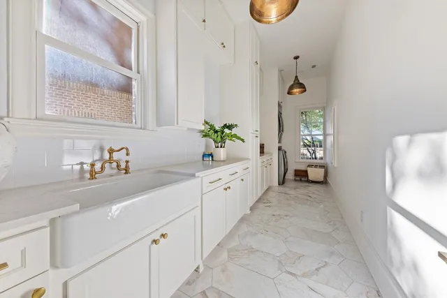 a spacious bathroom with a granite countertop sink and a bathtub
