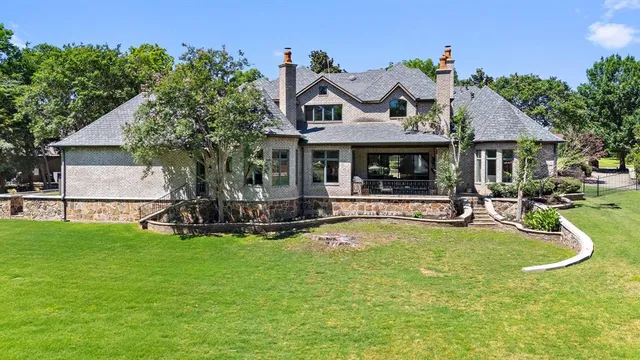 a view of a house with swimming pool and sitting area