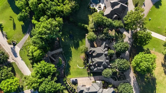 an aerial view of a house with a yard outdoor seating