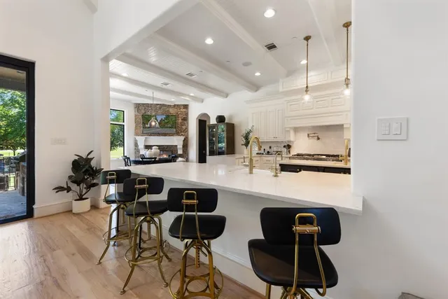 a kitchen with a sink cabinets and wooden floor