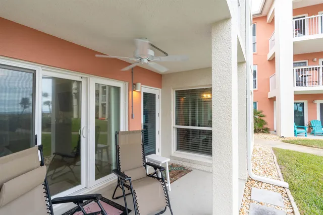 a row of palm trees in front of a house