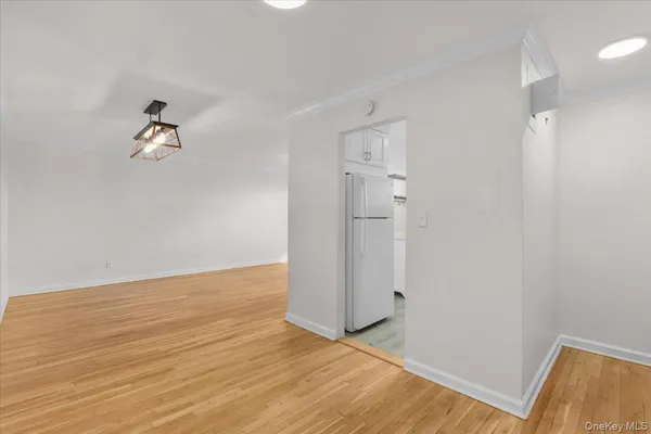 a view of a room with wooden floor and ceiling fan