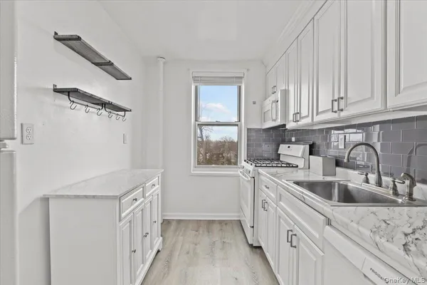a kitchen with a sink cabinets and window