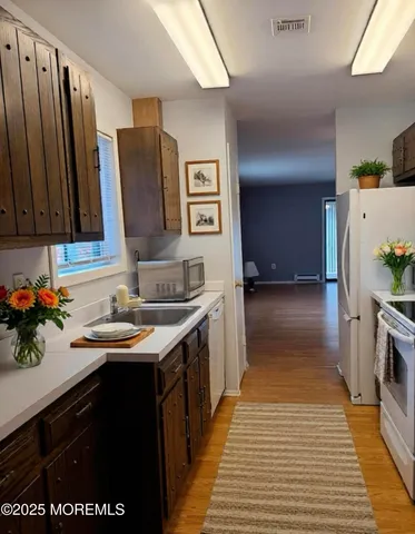 a kitchen with stainless steel appliances a sink stove and cabinets