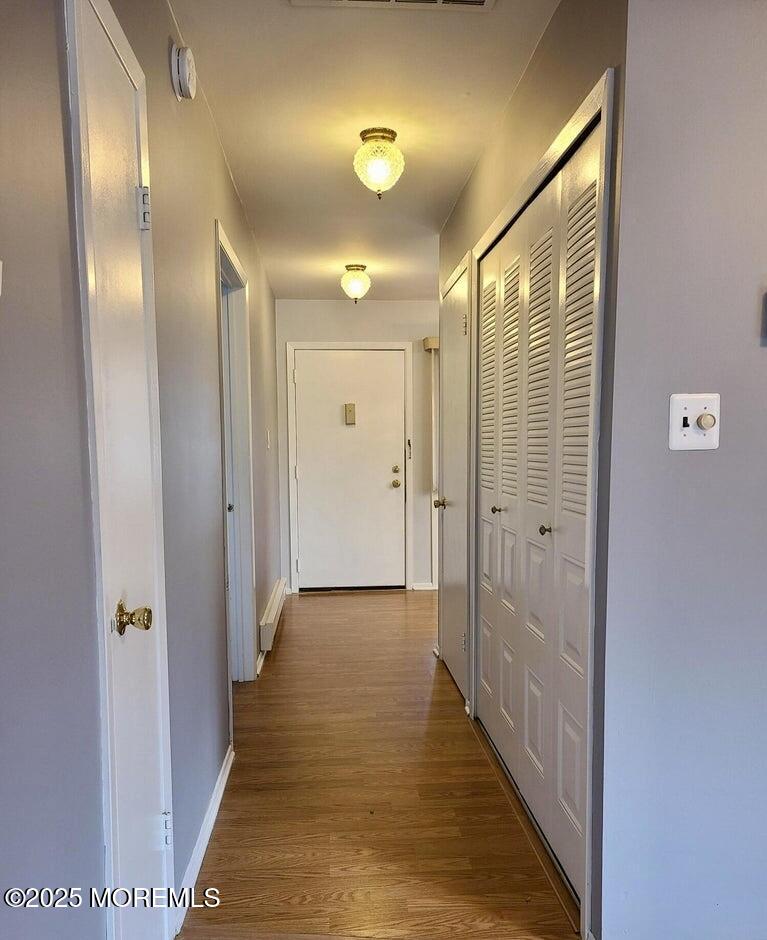 141 Cross Slope Court, Unit A Manalapan, NJ 07726 - Photo 6 of 11 a view of a hallway with wooden floor