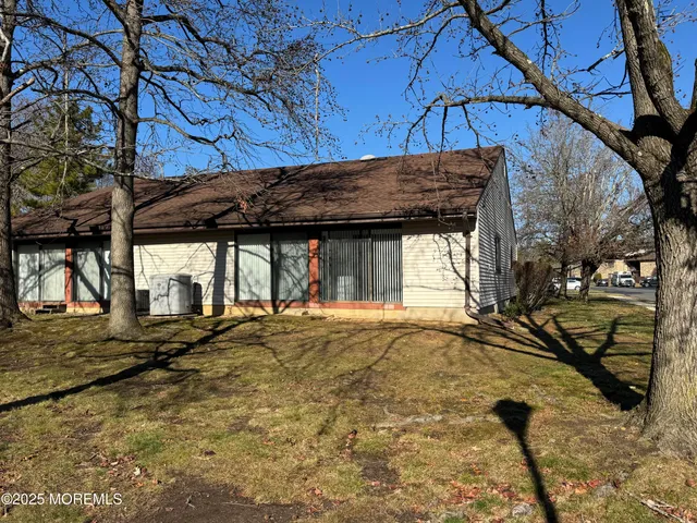 a view of a house with a large tree