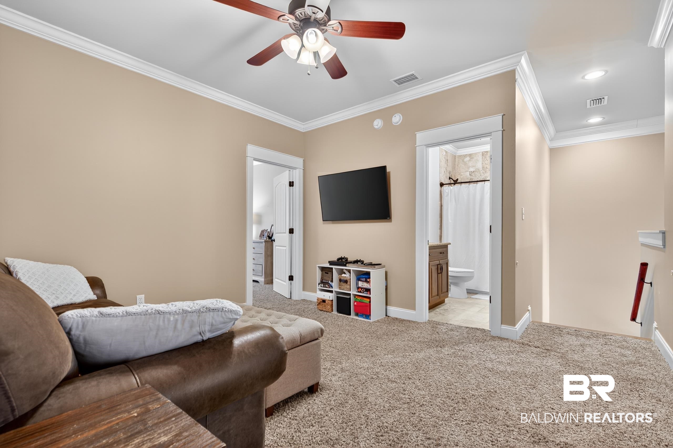 5517 Rabbit Creek Drive Theodore, AL 36582 - Photo 23 of 33 Versatile and open space works well as a cozy hangout, a TV spot, or even a quiet reading nook. It features crown molding, light carpet, ceiling fan, and recessed lighting.