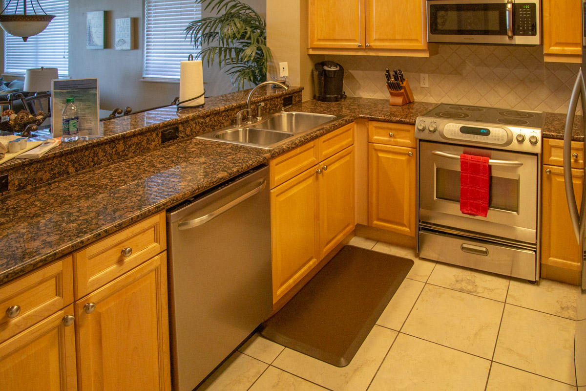 1150 Santa Rosa Boulevard, Unit 223 Fort Walton Beach, FL 32548 - Photo 16 of 35 a kitchen with stainless steel appliances granite countertop a sink stove and cabinets