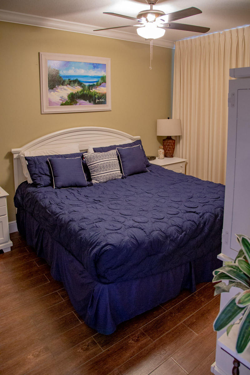 1150 Santa Rosa Boulevard, Unit 223 Fort Walton Beach, FL 32548 - Photo 22 of 35 a bedroom with a bed and a painting on the wall