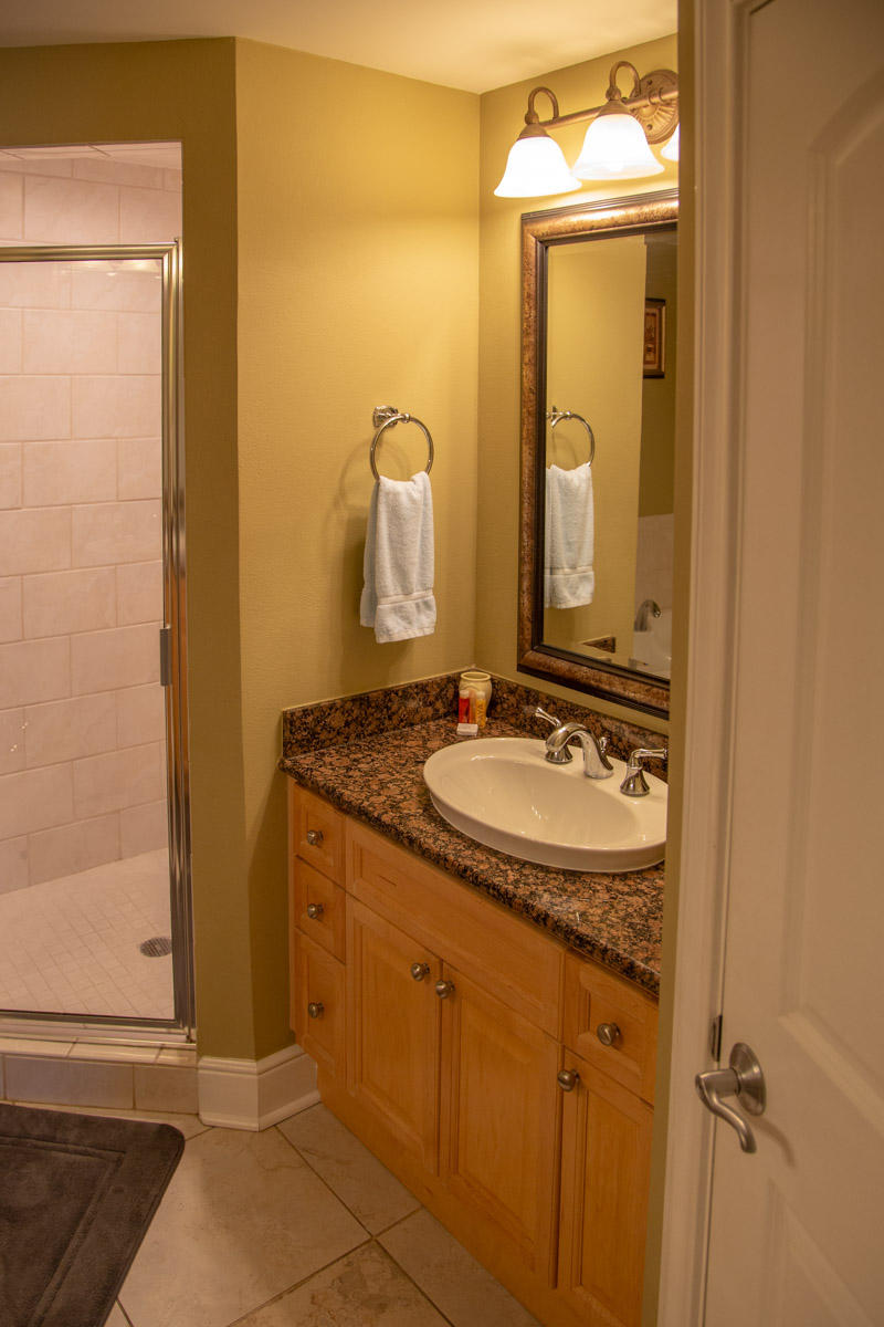 1150 Santa Rosa Boulevard, Unit 223 Fort Walton Beach, FL 32548 - Photo 24 of 35 a bathroom with a granite countertop sink and a mirror