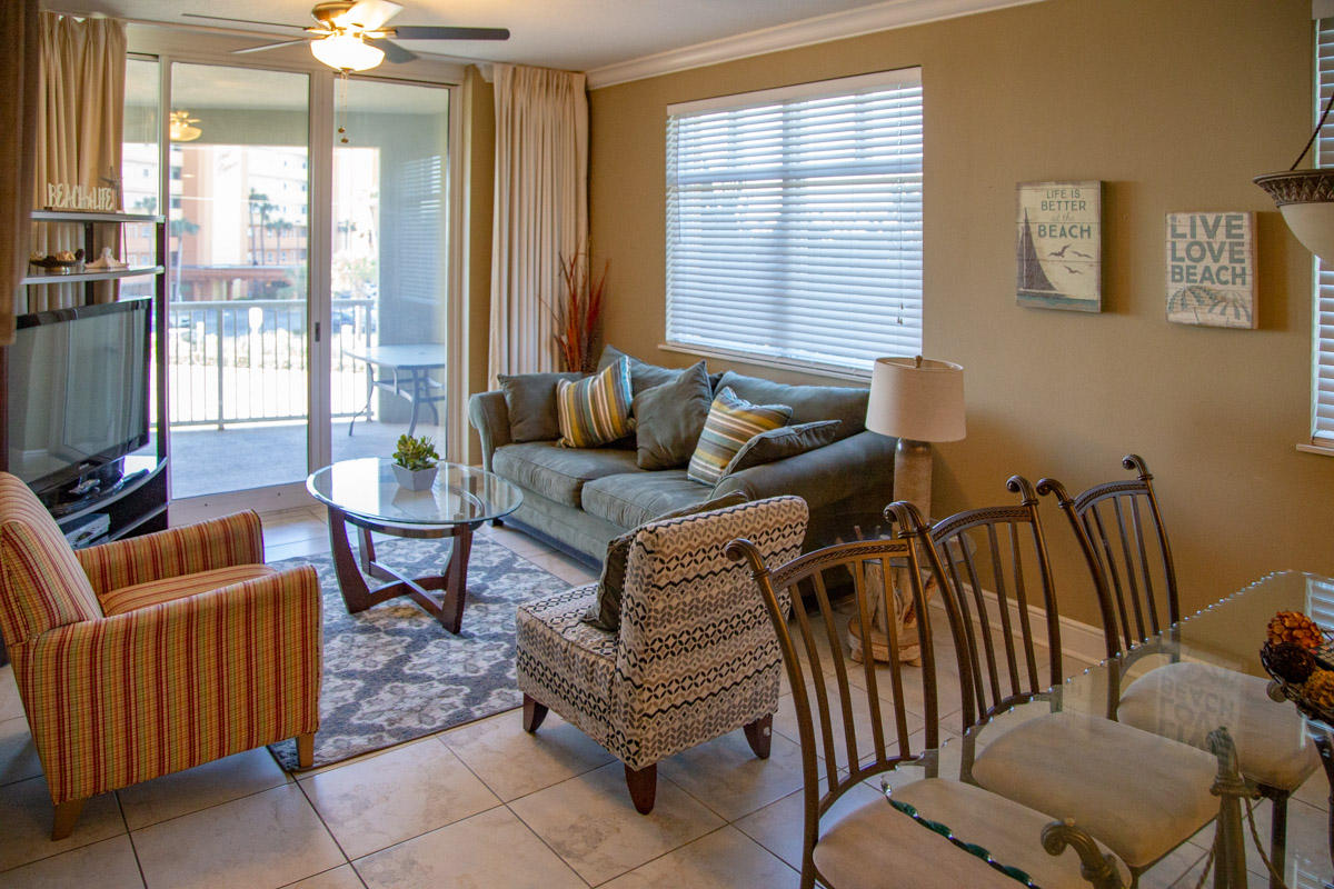 1150 Santa Rosa Boulevard, Unit 223 Fort Walton Beach, FL 32548 - Photo 4 of 35 a living room with furniture and a floor to ceiling window