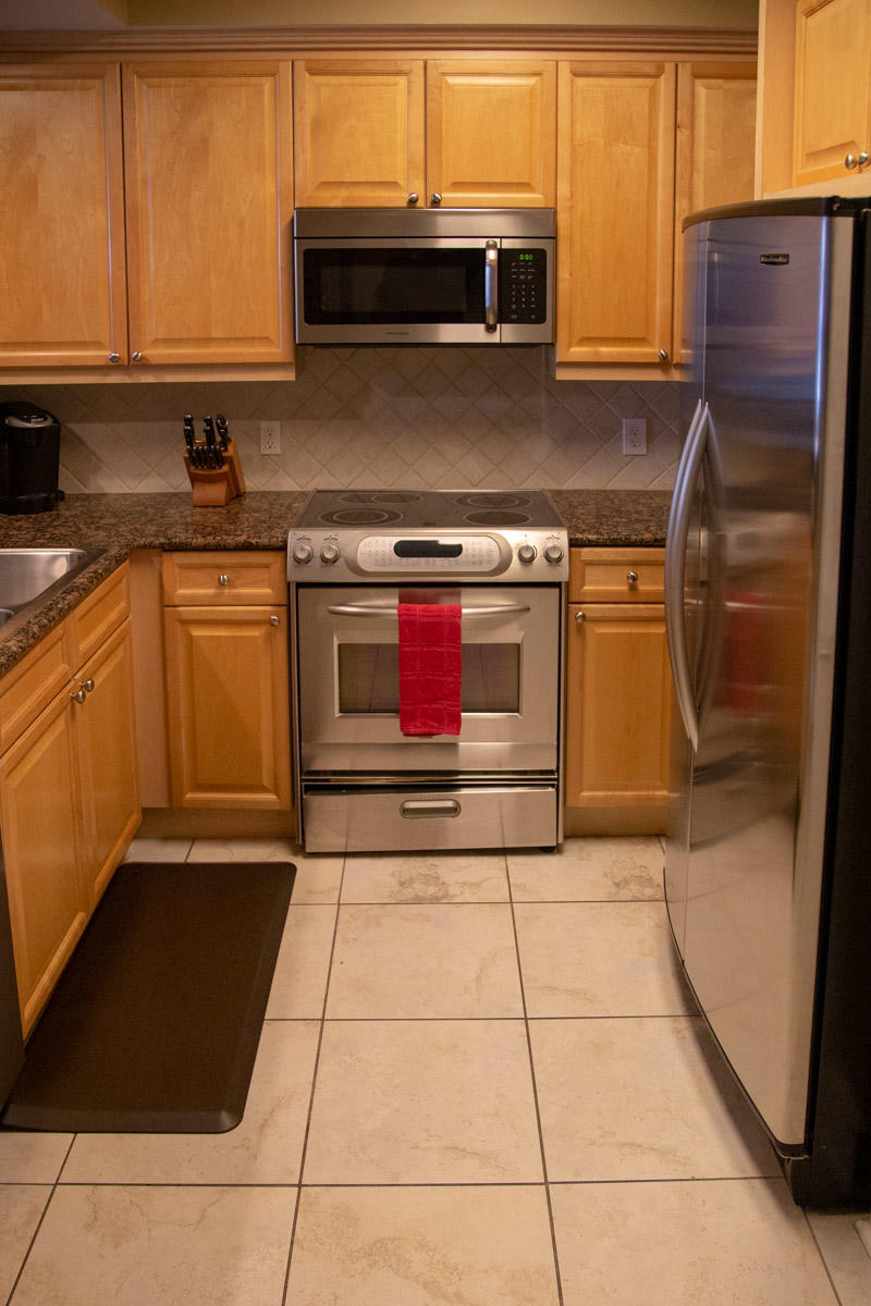 1150 Santa Rosa Boulevard, Unit 223 Fort Walton Beach, FL 32548 - Photo 10 of 35 a kitchen with stainless steel appliances granite countertop a stove a sink and a microwave