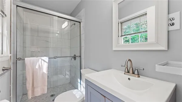 a bathroom with a sink toilet and shower