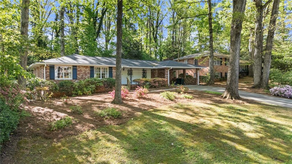 2235 Winding Way Tucker, GA 30084 - Photo 2 of 31 a front view of a house with a yard table and chairs