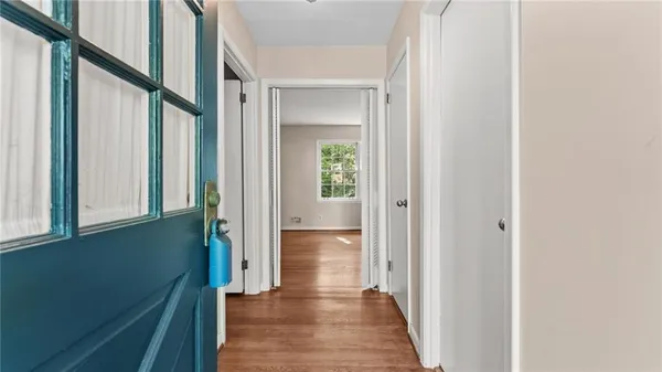 a view of a hallway with wooden floor and staircase