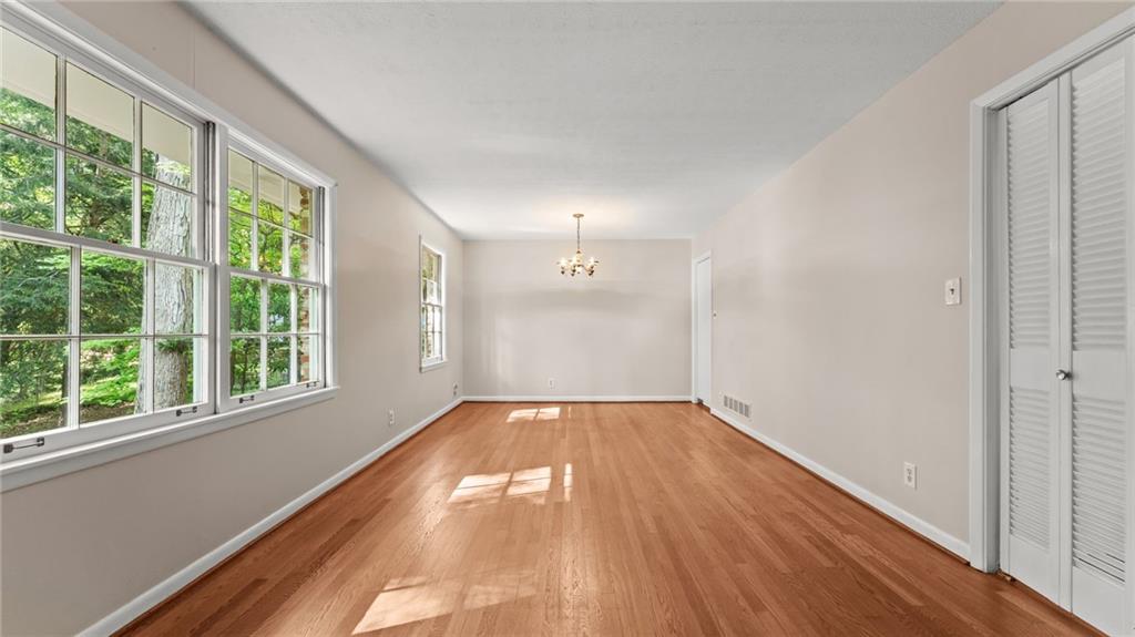2235 Winding Way Tucker, GA 30084 - Photo 5 of 31 a view of an empty room with wooden floor and a window