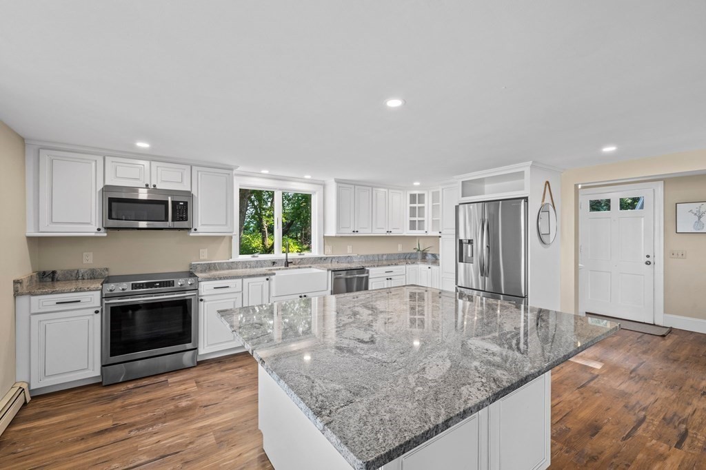 42 Damons Point Circle Marshfield, MA 02050 - Photo 7 of 21 a kitchen with stainless steel appliances granite countertop a stove a sink and a refrigerator