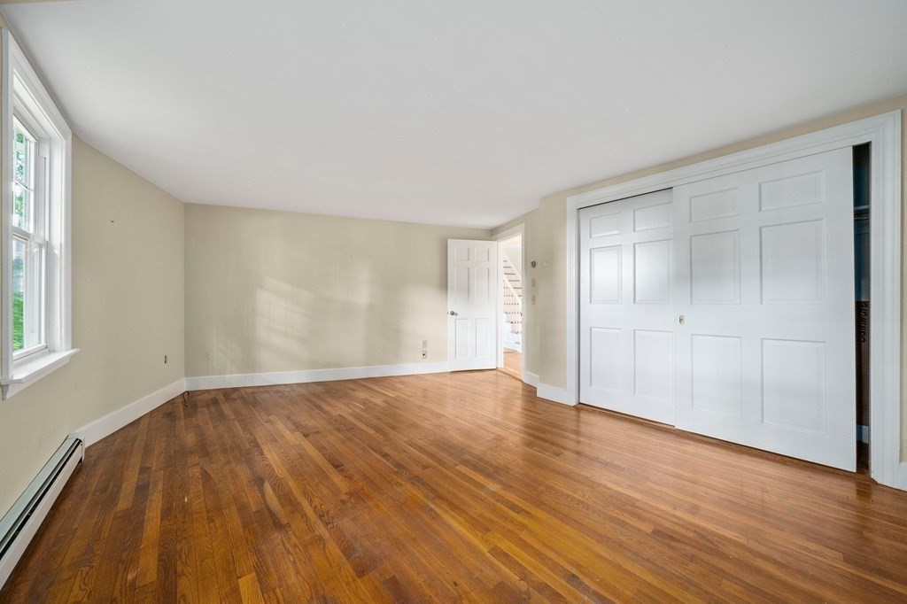 42 Damons Point Circle Marshfield, MA 02050 - Photo 10 of 21 a view of an empty room with wooden floor and a window