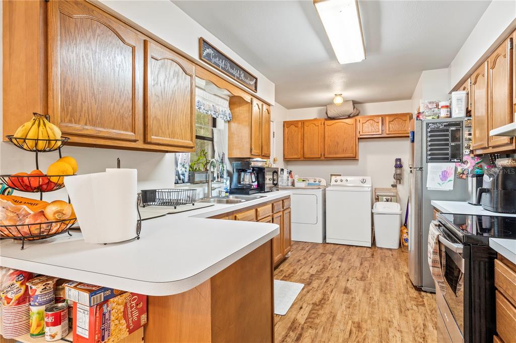 4113 288th Terrace Branford, FL 32008 - Photo 12 of 35 a kitchen with a refrigerator and a stove top oven