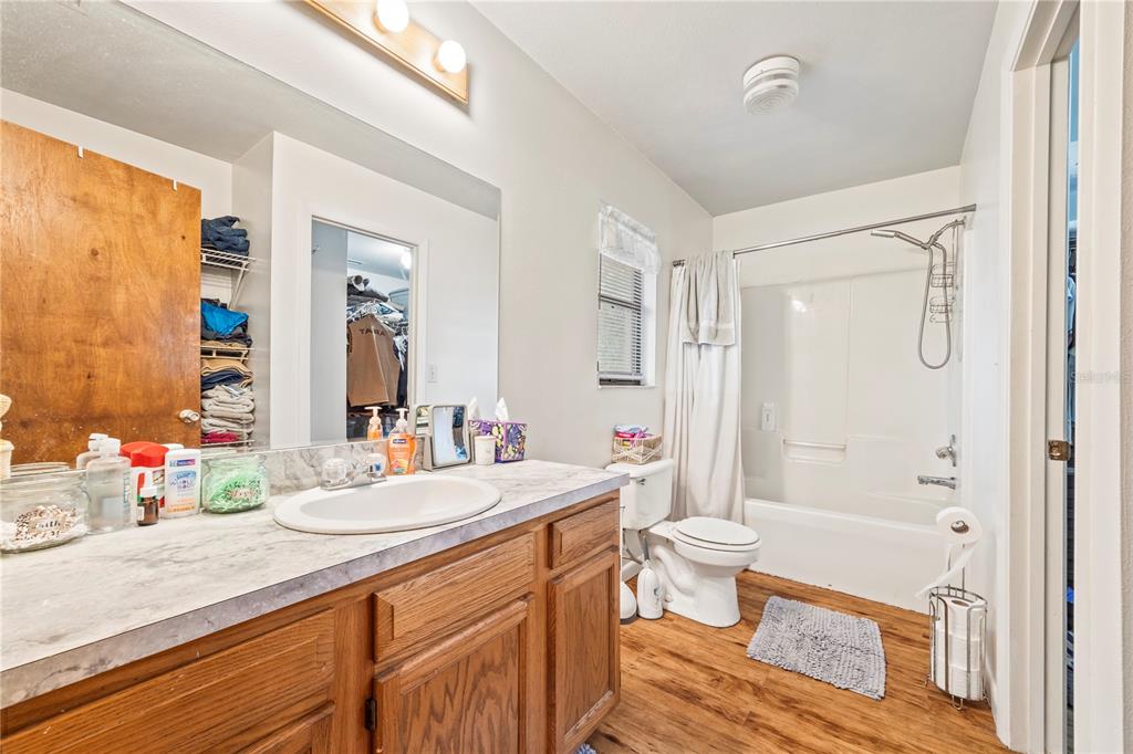 4113 288th Terrace Branford, FL 32008 - Photo 19 of 35 a bathroom with a double vanity sink toilet mirror and shower