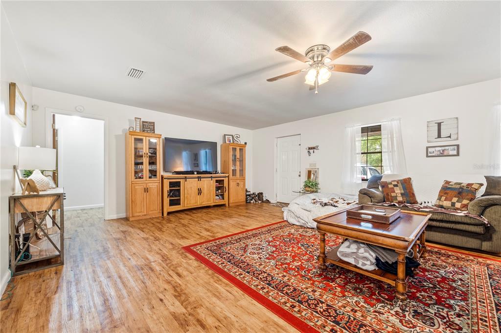 4113 288th Terrace Branford, FL 32008 - Photo 6 of 35 a living room with furniture and a wooden floor