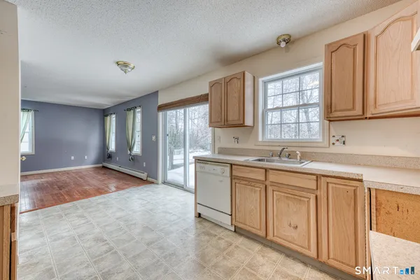 a large kitchen with kitchen island a sink window and cabinets