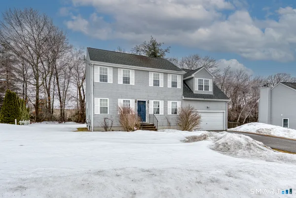 a view of a house with snow on the road