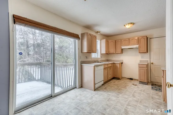 a kitchen with a refrigerator a stove top oven and a large window