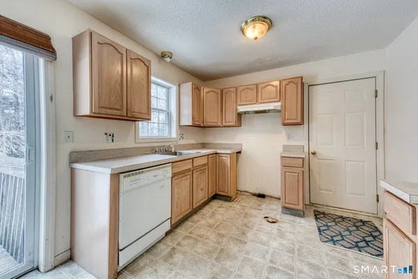 a kitchen with a stove a sink and a refrigerator
