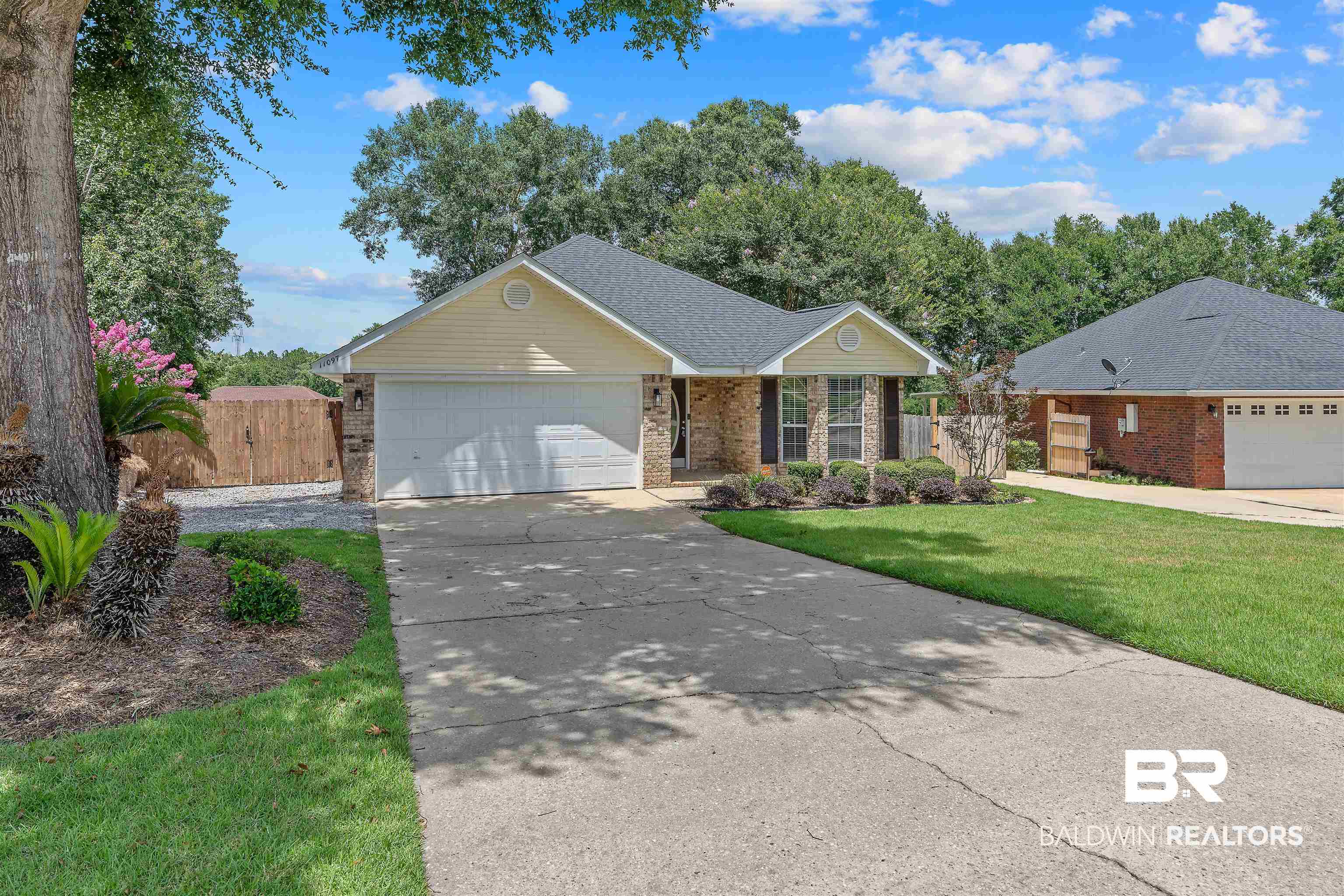 11097 Pontchartrain Loop Daphne, AL 36526 - Photo 3 of 28 Single story home featuring brick siding, driveway, a gate, and a garage