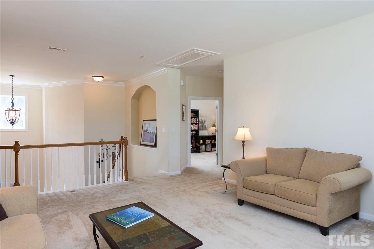 10121 Darling Street Raleigh, NC 27613 - Photo 15 of 25 a living room with furniture and a book shelf