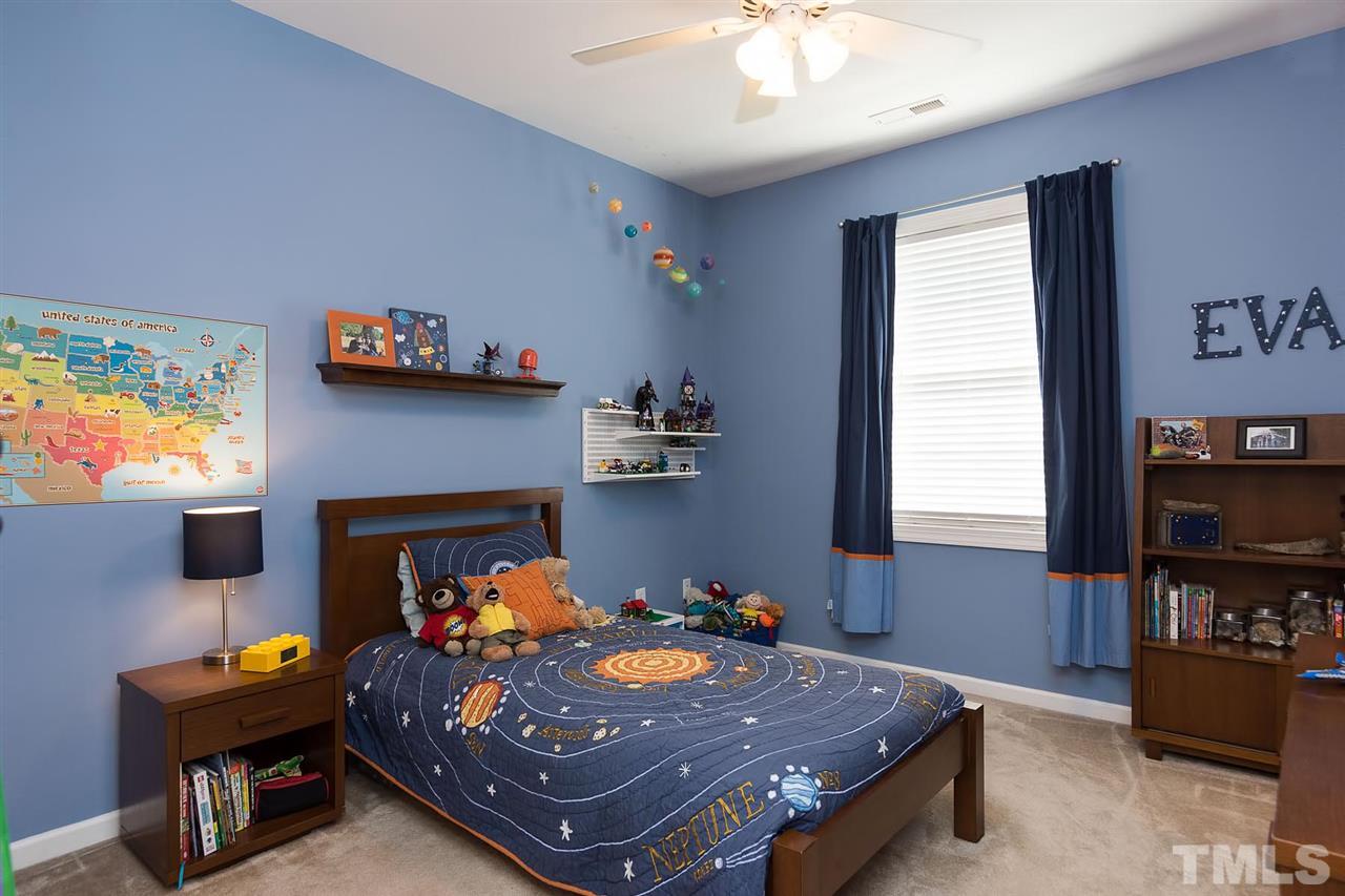 10121 Darling Street Raleigh, NC 27613 - Photo 20 of 25 a bed room with furniture and a fireplace