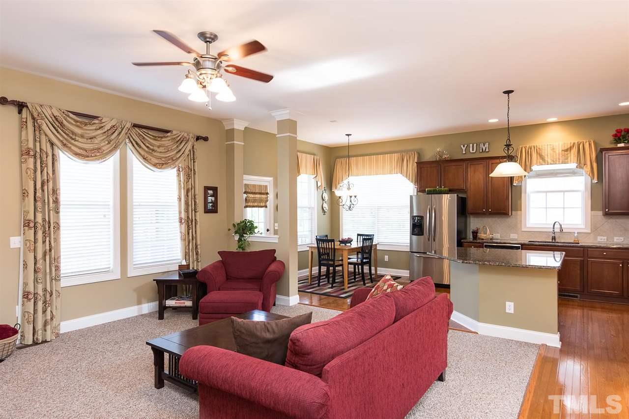10121 Darling Street Raleigh, NC 27613 - Photo 5 of 25 a living room with furniture a large window and a chandelier