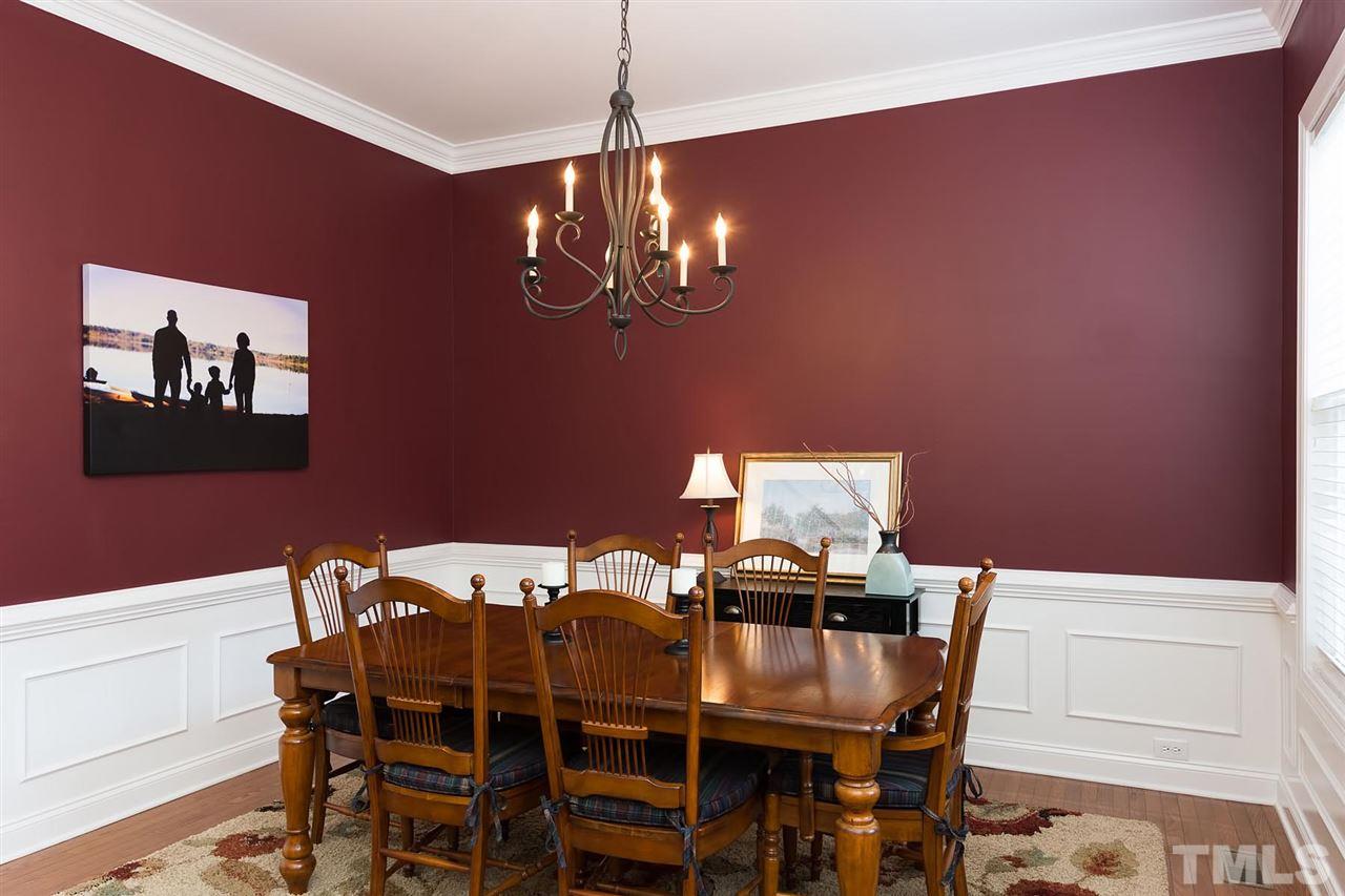 10121 Darling Street Raleigh, NC 27613 - Photo 8 of 25 a view of a dining room with furniture and chandelier