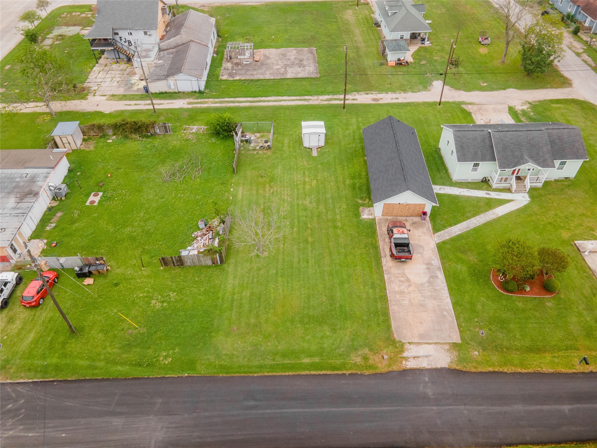 a green field with lots of tress in it