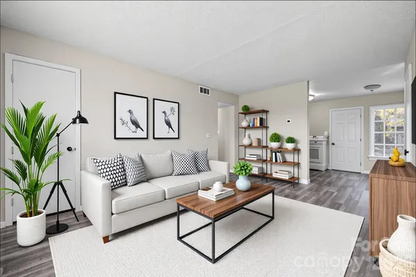 a living room with furniture and a potted plant