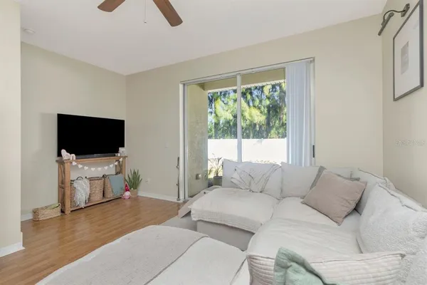 a living room with furniture and a wooden floor
